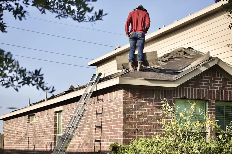 Professional roofer working on a residential roof in Spring Lake Park